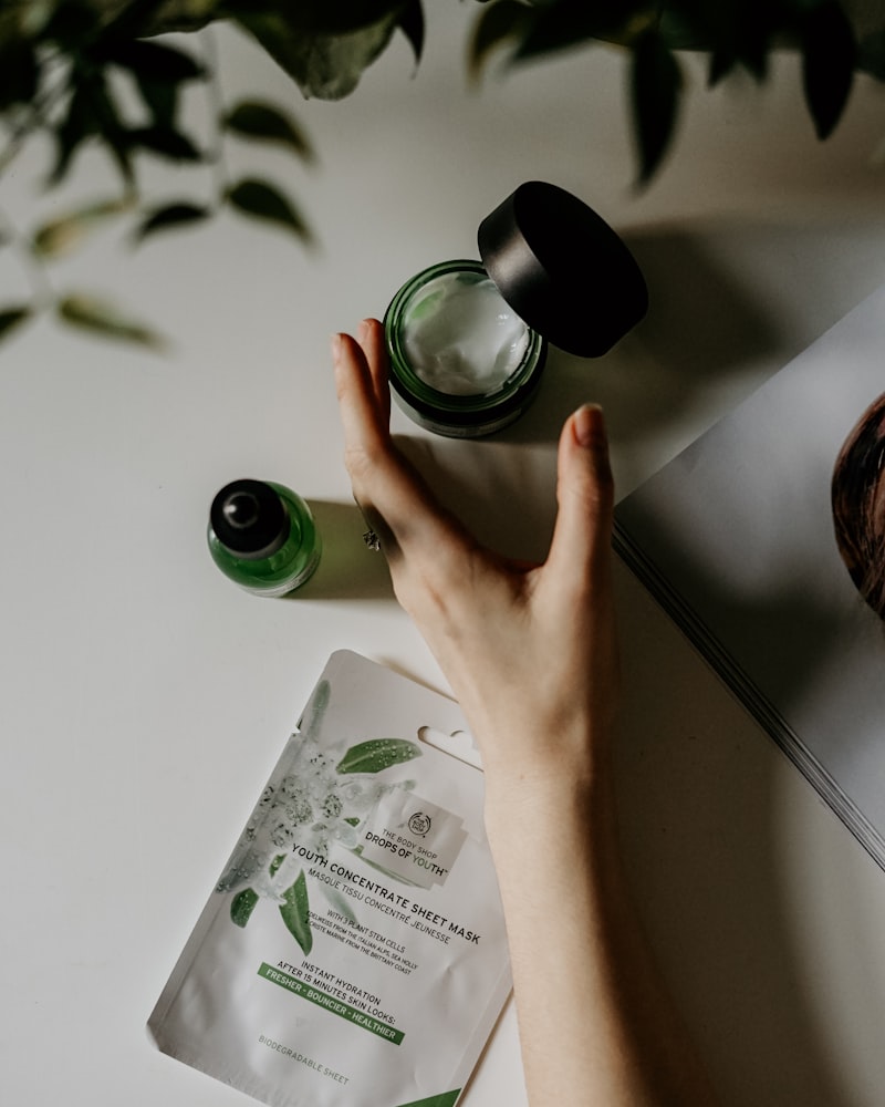 Glass bottles of botanical skincare arranged on linen